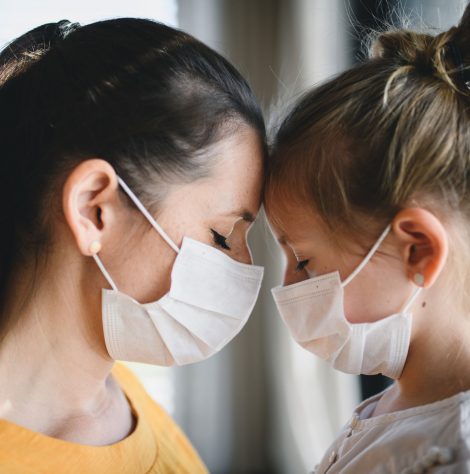 mother-and-child-with-face-masks-indoors-at-home-c-R6CGLQB.jpg
